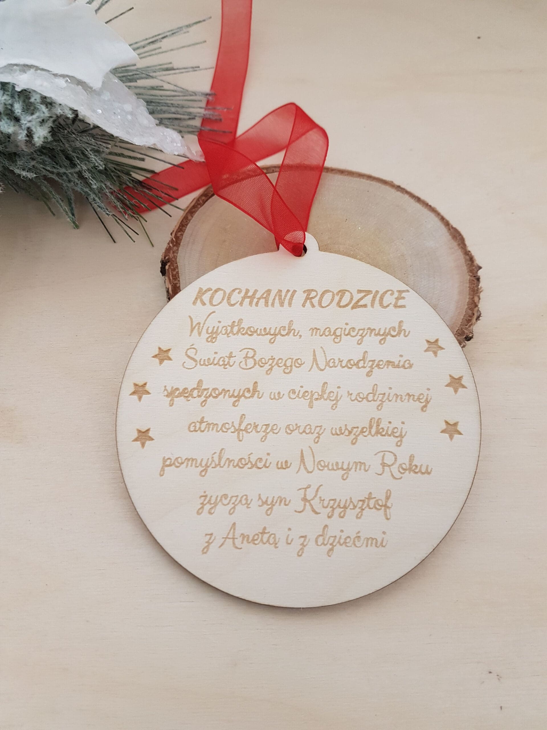 Drewniana bombka, zawieszka choinkowa z wygrawerowanymi życzeniami bożonarodzeniowymi